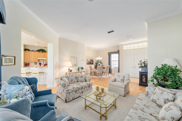 13165 SE 93rd Cir, Summerfield, FL 34491 - living area featuring crown molding, light wood-type flooring, and a chandelier