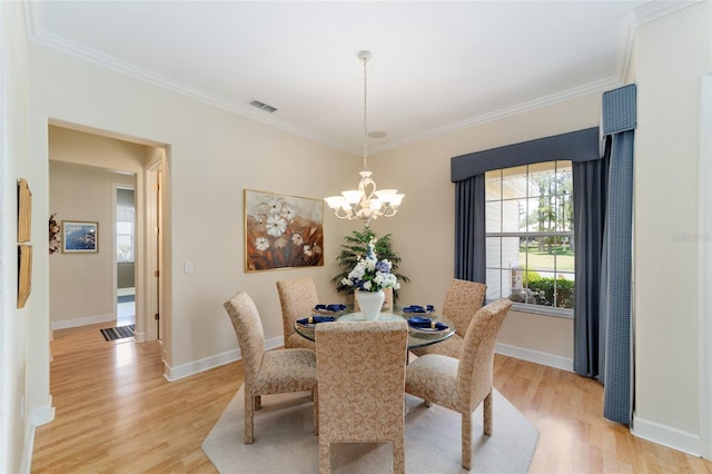 13165 SE 93rd Cir, Summerfield, FL 34491 - dining space with crown molding, a chandelier, light wood-style floors, and baseboards