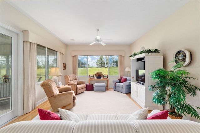 13165 SE 93rd Cir, Summerfield, FL 34491 - living area featuring a ceiling fan and light wood-style floors