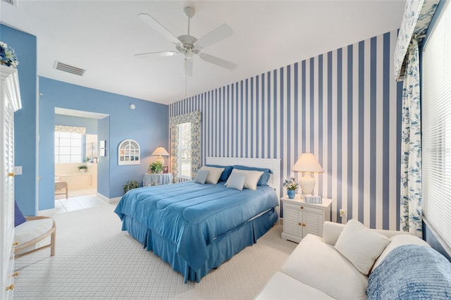 13165 SE 93rd Cir, Summerfield, FL 34491 - bedroom featuring wallpapered walls, ensuite bath, a ceiling fan, and carpet flooring