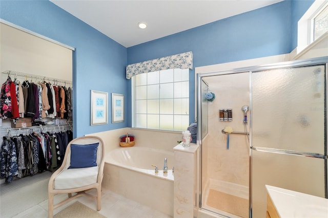 13165 SE 93rd Cir, Summerfield, FL 34491 - full bathroom with a bath, a shower stall, and a spacious closet