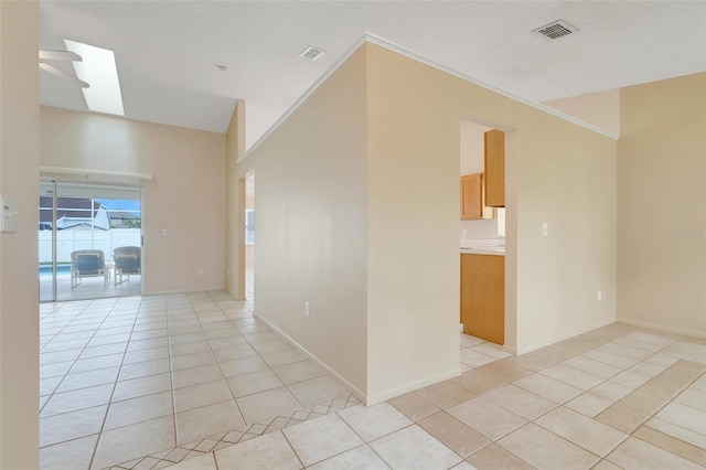 2896 Picadilly Cir, Kissimmee, FL 34747 - spare room featuring light tile patterned floors, a skylight, baseboards, and crown molding