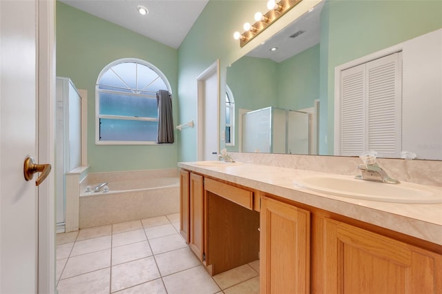 2896 Picadilly Cir, Kissimmee, FL 34747 - bathroom featuring double vanity, a shower stall, a bath, tile patterned flooring, and a closet