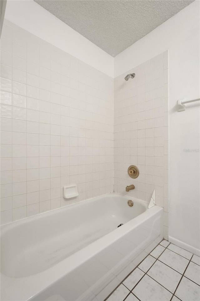 2896 Picadilly Cir, Kissimmee, FL 34747 - bathroom with tile patterned flooring,  shower combination, a textured ceiling, and baseboards