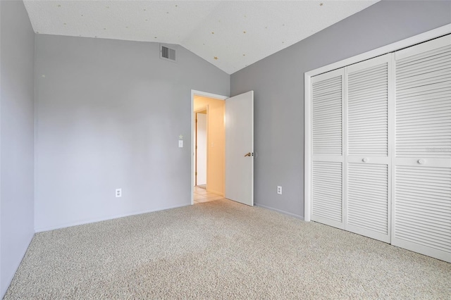 2896 Picadilly Cir, Kissimmee, FL 34747 - unfurnished bedroom featuring light carpet, lofted ceiling, a closet, and baseboards