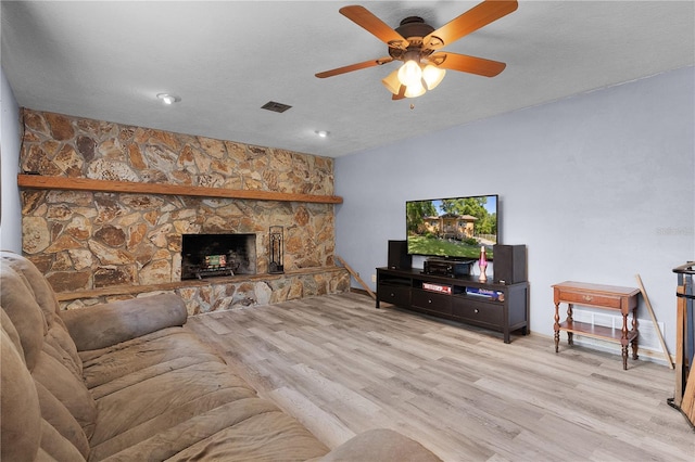 5581 SW 197th Ter, Dunnellon, FL 34431 - living room with wood finished floors, ceiling fan, and a fireplace