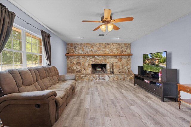 5581 SW 197th Ter, Dunnellon, FL 34431 - living room featuring light wood-style flooring, ceiling fan, and a stone fireplace