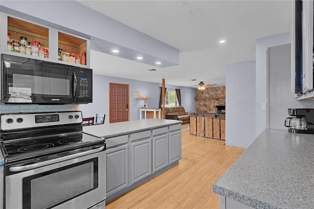 5581 SW 197th Ter, Dunnellon, FL 34431 - kitchen with electric stove, black microwave, recessed lighting, a ceiling fan, and a peninsula