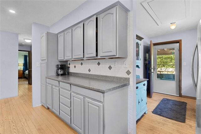 5581 SW 197th Ter, Dunnellon, FL 34431 - kitchen with gray cabinetry, light wood-style flooring, and dark countertops