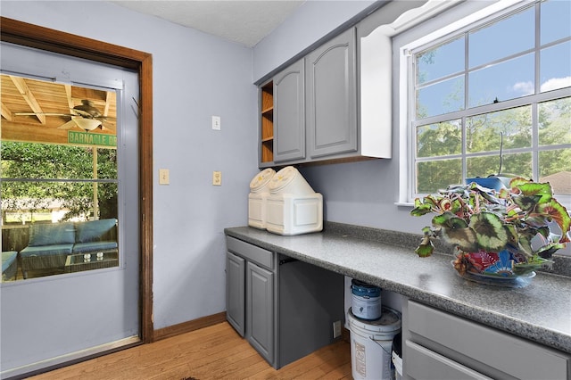 5581 SW 197th Ter, Dunnellon, FL 34431 - kitchen with gray cabinets, light wood-style floors, dark countertops, open shelves, and baseboards