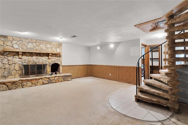 5581 SW 197th Ter, Dunnellon, FL 34431 - below grade area with wainscoting, stairway, a stone fireplace, and wooden walls