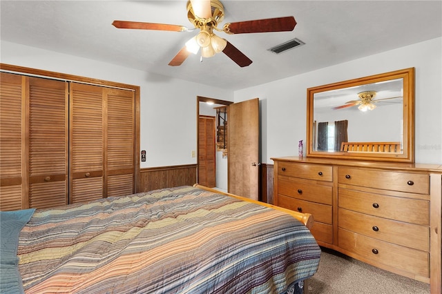 5581 SW 197th Ter, Dunnellon, FL 34431 - bedroom with carpet floors, wainscoting, a closet, ceiling fan, and wood walls