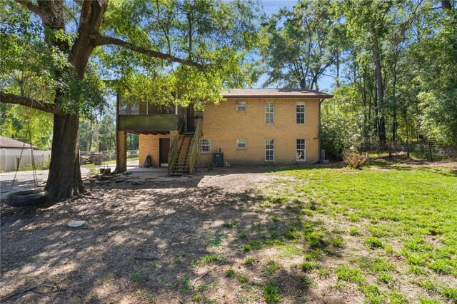 5581 SW 197th Ter, Dunnellon, FL 34431 - back of house featuring stairs, brick siding, and a sunroom