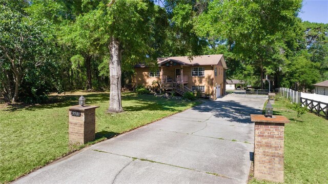 5581 SW 197th Ter, Dunnellon, FL 34431 - view of front facade featuring stairs and driveway