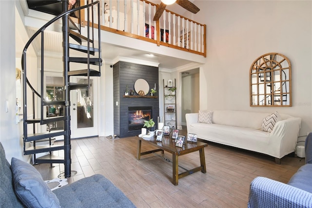 1226 Overlook Rd, Eustis, FL 32726 - living room with stairway, wood finished floors, a fireplace, a high ceiling, and a ceiling fan