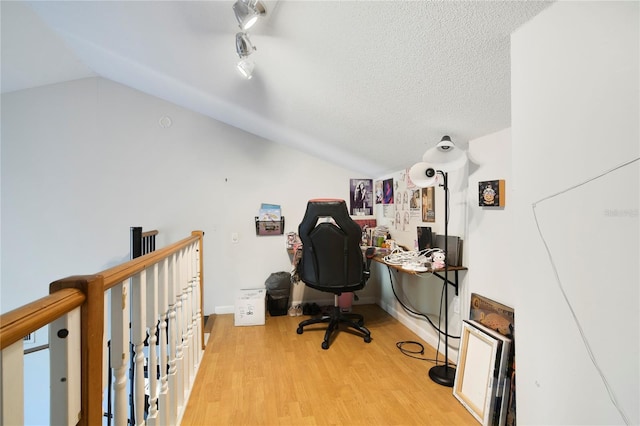 1226 Overlook Rd, Eustis, FL 32726 - office space with vaulted ceiling, wood finished floors, and a textured ceiling