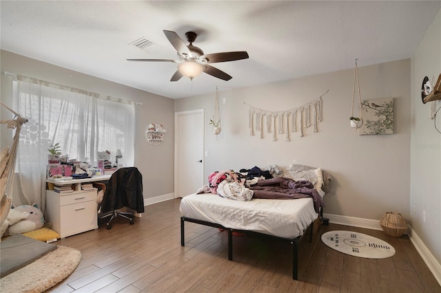 1226 Overlook Rd, Eustis, FL 32726 - bedroom featuring wood finished floors, a desk, baseboards, and a ceiling fan