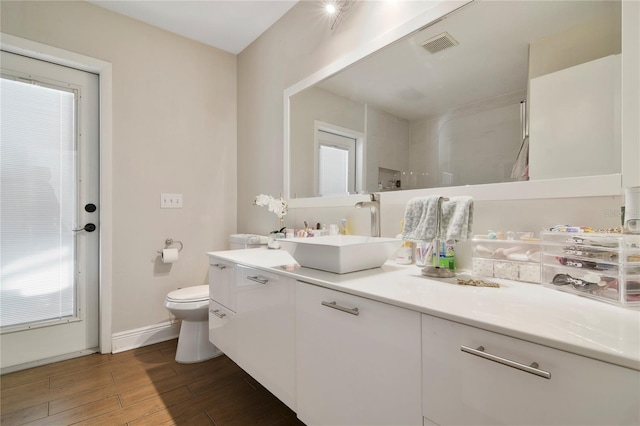 1226 Overlook Rd, Eustis, FL 32726 - bathroom featuring vanity, toilet, wood finished floors, baseboards, and a shower
