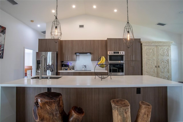 11036 Bronson Rd, Clermont, FL 34711 - kitchen with light countertops, appliances with stainless steel finishes, high vaulted ceiling, a breakfast bar area, and ventilation hood