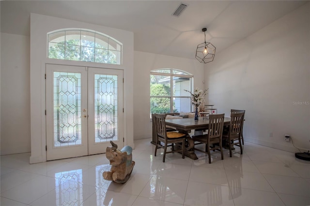 11036 Bronson Rd, Clermont, FL 34711 - foyer entrance with french doors, light tile patterned floors, and a high ceiling