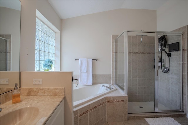11036 Bronson Rd, Clermont, FL 34711 - bathroom with vanity, a shower stall, a garden tub, and vaulted ceiling