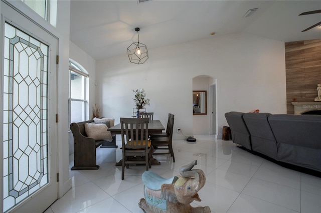 11036 Bronson Rd, Clermont, FL 34711 - dining room featuring arched walkways, vaulted ceiling, ceiling fan, and light tile patterned floors