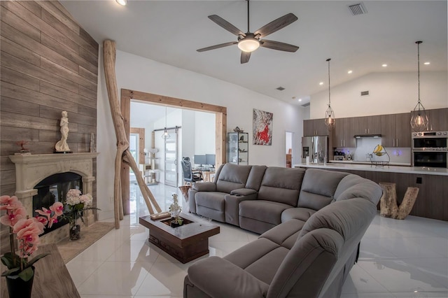 11036 Bronson Rd, Clermont, FL 34711 - living area with light tile patterned floors, a ceiling fan, recessed lighting, high vaulted ceiling, and a large fireplace