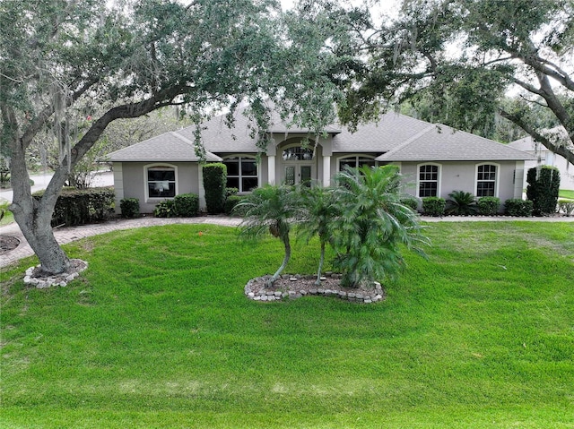 11036 Bronson Rd, Clermont, FL 34711 - ranch-style home featuring french doors, stucco siding, a front lawn, and roof with shingles