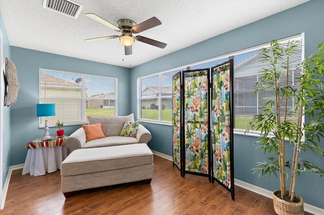 612 Lisbon Ln, The Villages, FL 32159 - living area featuring ceiling fan, baseboards, wood finished floors, and a textured ceiling