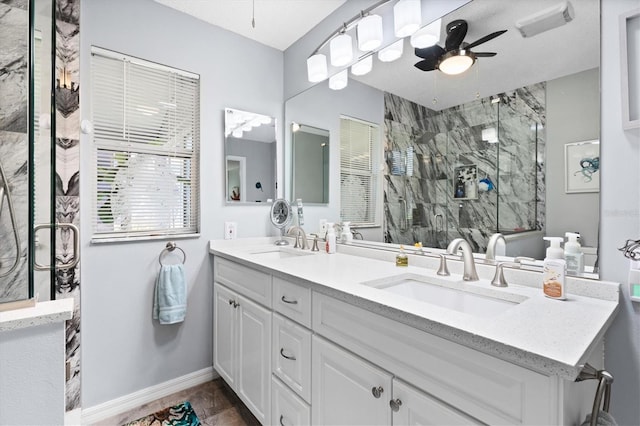 612 Lisbon Ln, The Villages, FL 32159 - full bath featuring double vanity, a ceiling fan, a marble finish shower, and baseboards