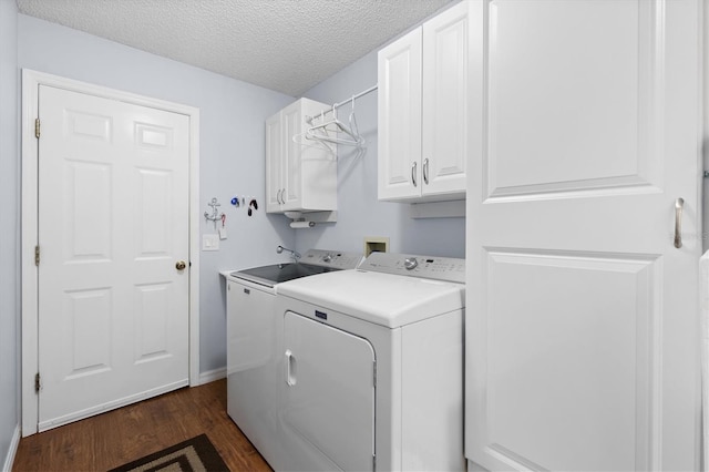 612 Lisbon Ln, The Villages, FL 32159 - laundry room with cabinet space, separate washer and dryer, dark wood finished floors, a textured ceiling, and baseboards