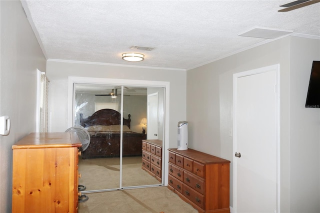 705 Poinsettia Ave, Fruitland Park, FL 34731 - bedroom featuring a closet, light carpet, a textured ceiling, and crown molding
