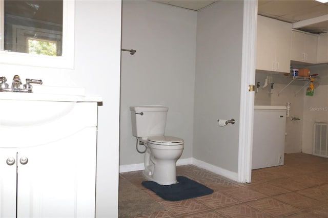 705 Poinsettia Ave, Fruitland Park, FL 34731 - bathroom featuring vanity, toilet, tile patterned floors, and baseboards