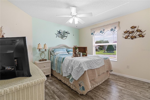 8980 SE 176th Limerick Ln, The Villages, FL 32162 - bedroom featuring wood finished floors, ceiling fan, baseboards, and a textured ceiling