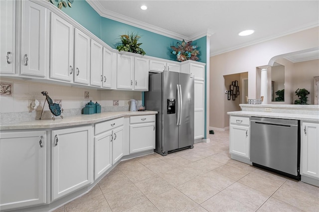 8980 SE 176th Limerick Ln, The Villages, FL 32162 - kitchen featuring appliances with stainless steel finishes, light tile patterned floors, light countertops, ornamental molding, and white cabinetry