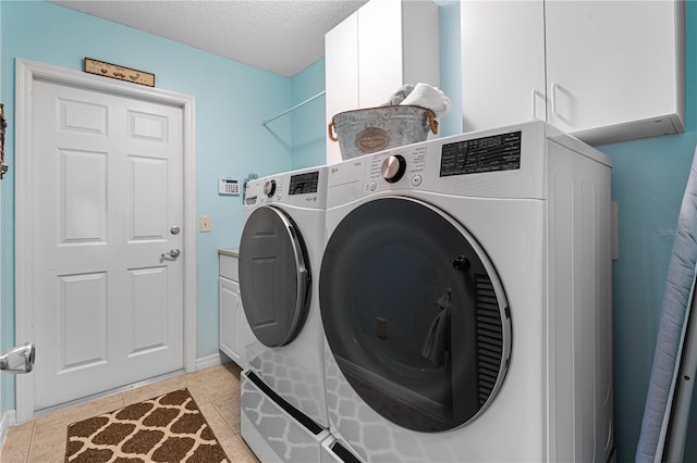 8980 SE 176th Limerick Ln, The Villages, FL 32162 - washroom with cabinet space, washer and clothes dryer, a textured ceiling, light tile patterned flooring, and baseboards
