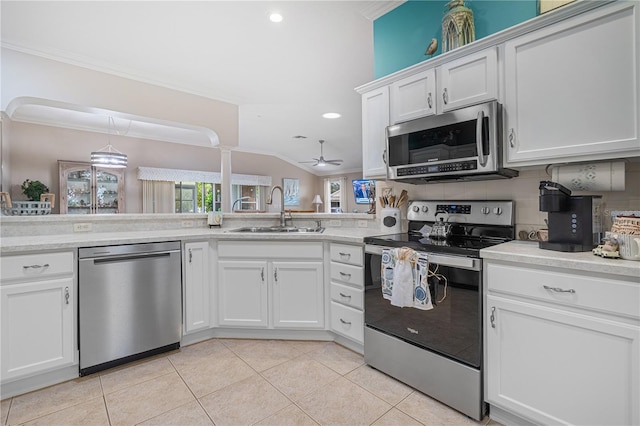 8980 SE 176th Limerick Ln, The Villages, FL 32162 - kitchen with stainless steel appliances, a sink, ornamental molding, a ceiling fan, and recessed lighting