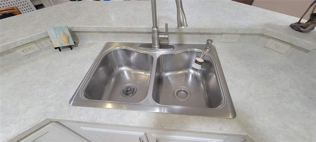 8980 SE 176th Limerick Ln, The Villages, FL 32162 - kitchen view of a sink, light countertops, and white cabinets