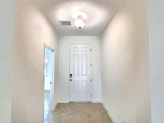 358 Switchgrass Loop, Minneola, FL 34715 - hallway featuring light tile patterned floors, a textured ceiling, and baseboards