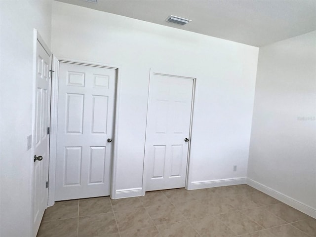 358 Switchgrass Loop, Minneola, FL 34715 - unfurnished bedroom featuring light tile patterned flooring and baseboards
