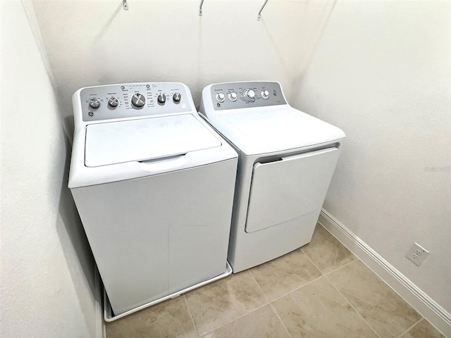 358 Switchgrass Loop, Minneola, FL 34715 - laundry area featuring separate washer and dryer, light tile patterned flooring, and baseboards