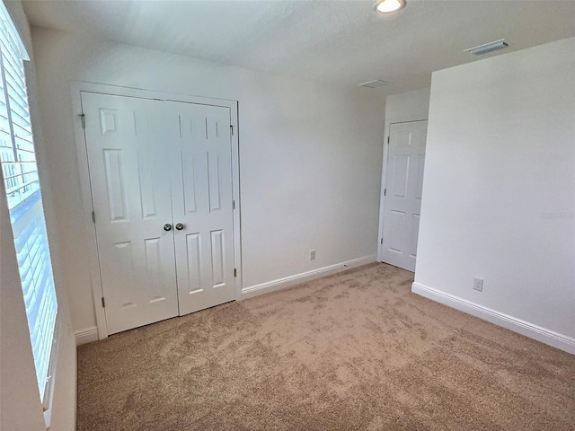358 Switchgrass Loop, Minneola, FL 34715 - unfurnished bedroom with carpet floors, baseboards, a closet, and recessed lighting