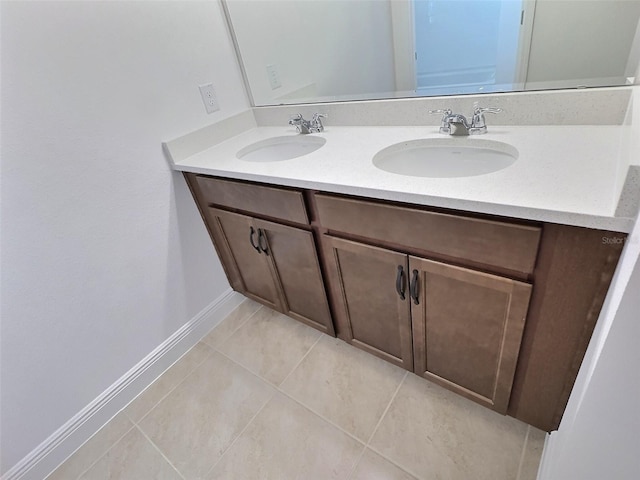 358 Switchgrass Loop, Minneola, FL 34715 - bathroom featuring double vanity, tile patterned flooring, and baseboards