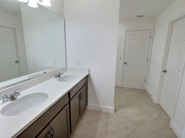 358 Switchgrass Loop, Minneola, FL 34715 - bathroom featuring double vanity, tile patterned flooring, and baseboards