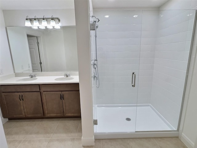 358 Switchgrass Loop, Minneola, FL 34715 - full bathroom with a stall shower, tile patterned floors, double vanity, and baseboards