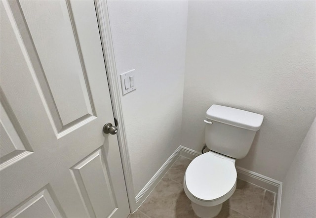 358 Switchgrass Loop, Minneola, FL 34715 - bathroom featuring toilet, baseboards, and tile patterned floors