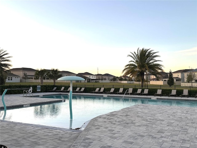 358 Switchgrass Loop, Minneola, FL 34715 - pool at dusk featuring a patio area and a community pool