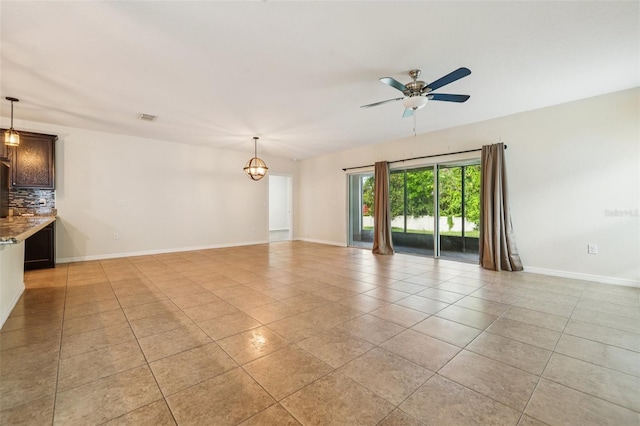 185 Hamlet Loop, Davenport, FL 33837 - unfurnished living room with light tile patterned floors and a ceiling fan