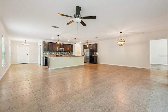 185 Hamlet Loop, Davenport, FL 33837 - unfurnished living room with light tile patterned floors, a chandelier, a ceiling fan, and recessed lighting