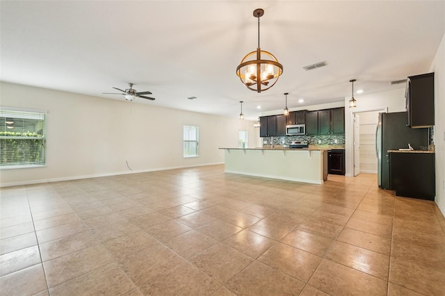 185 Hamlet Loop, Davenport, FL 33837 - unfurnished living room featuring light tile patterned flooring, a ceiling fan, a chandelier, and recessed lighting
